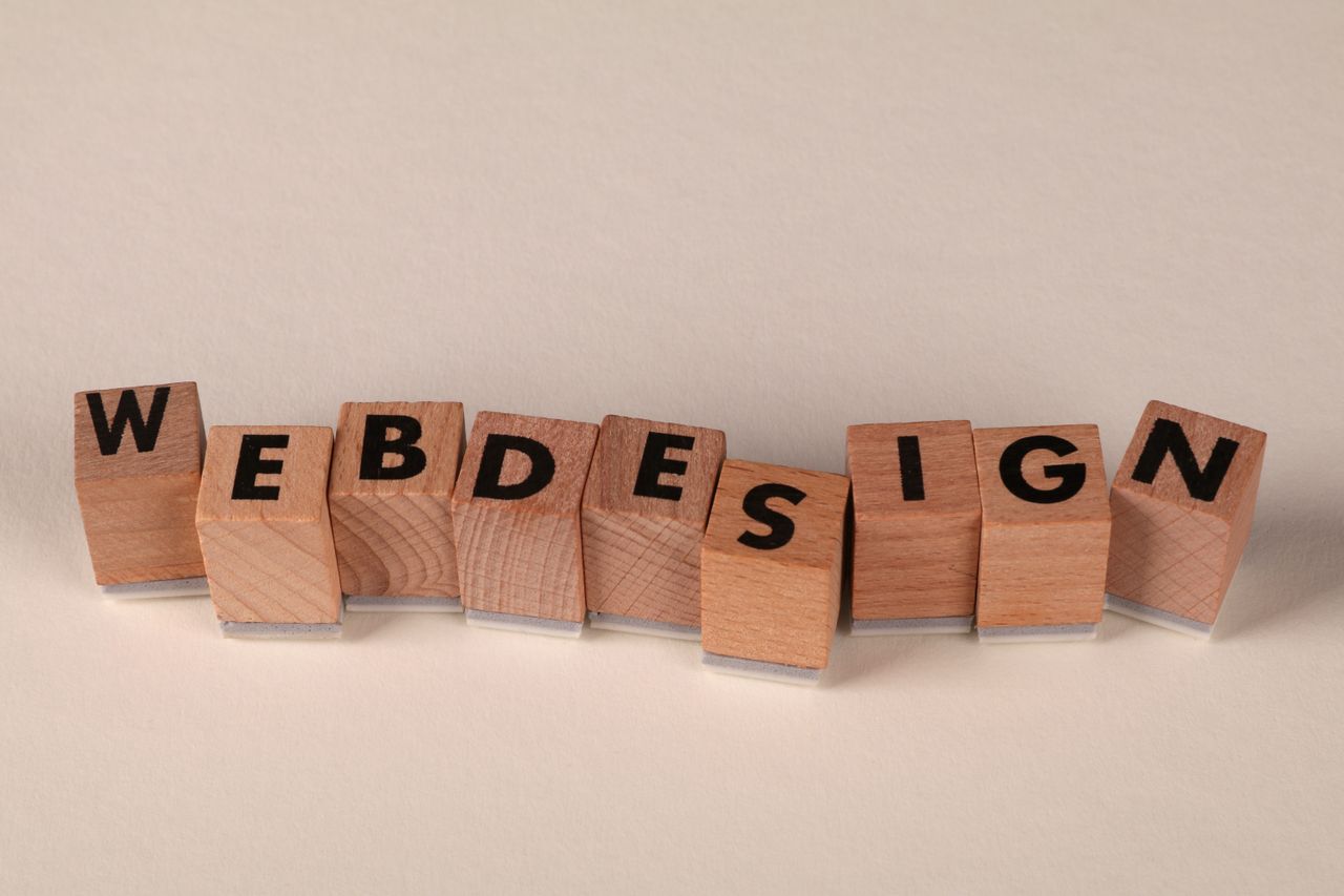 heros-img Wooden blocks spelling web design creatively showcase digital design concept.